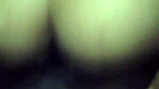Hooded woman making oral pleasure an African man
