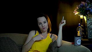A brunette is seductively smoking while she looks at you